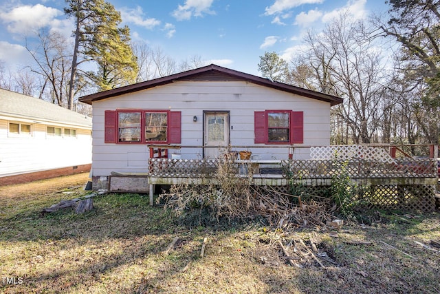 rear view of house with a yard and a deck