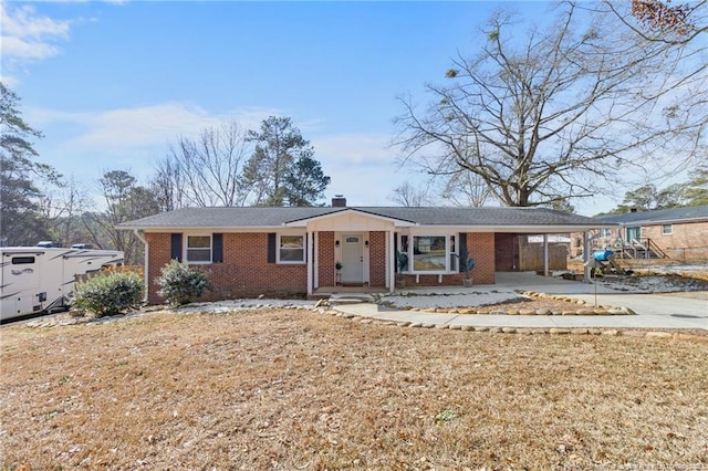 ranch-style home featuring a carport and a front yard