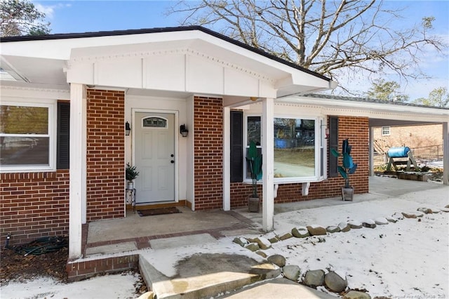 view of snow covered property entrance