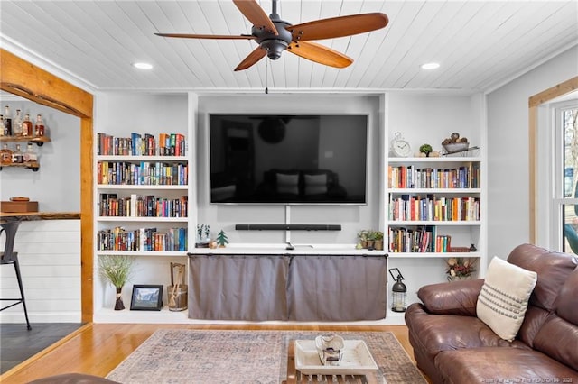 living room with ceiling fan, wood-type flooring, and wooden ceiling