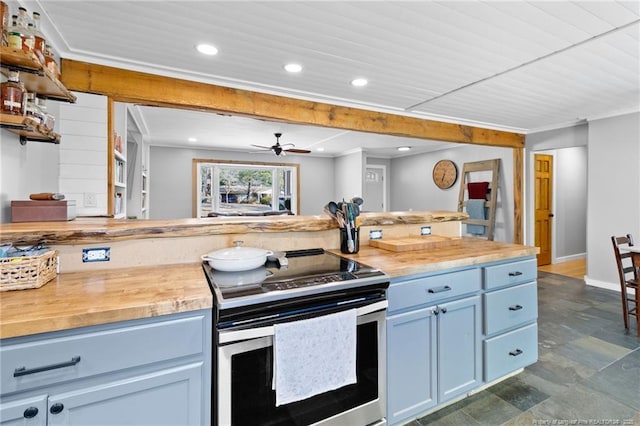 kitchen with butcher block counters, stainless steel electric stove, ceiling fan, and blue cabinets