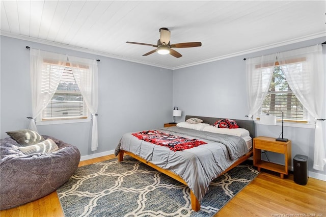 bedroom with crown molding, ceiling fan, and hardwood / wood-style floors