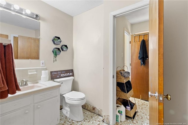 bathroom featuring tile patterned floors, toilet, and vanity