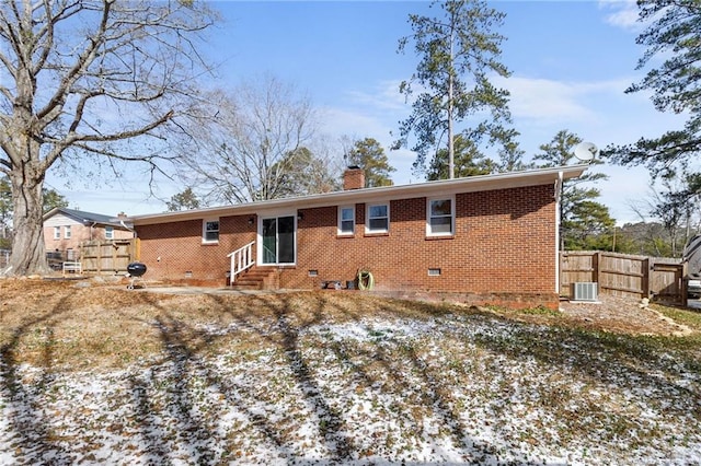 snow covered property featuring central AC unit