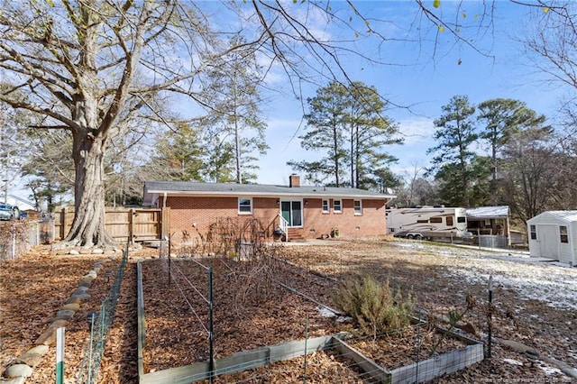 back of property with a storage shed