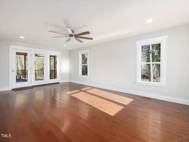 spare room featuring ceiling fan and dark hardwood / wood-style floors