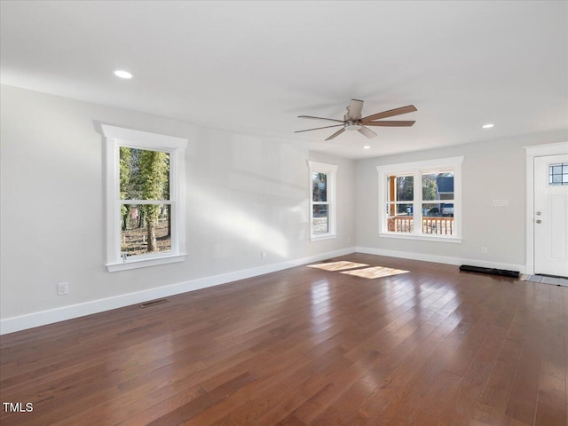 unfurnished living room featuring dark hardwood / wood-style floors and ceiling fan