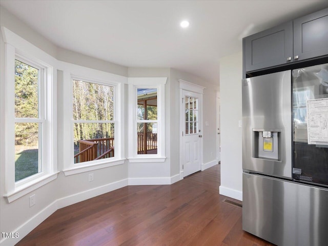 kitchen featuring gray cabinetry, stainless steel fridge, and dark hardwood / wood-style floors