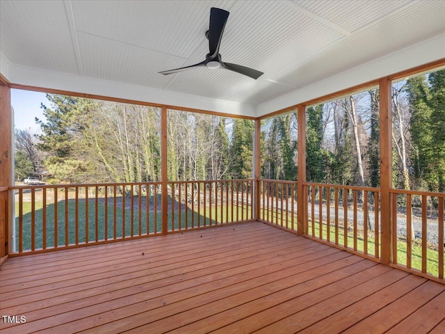 wooden deck with ceiling fan and a yard