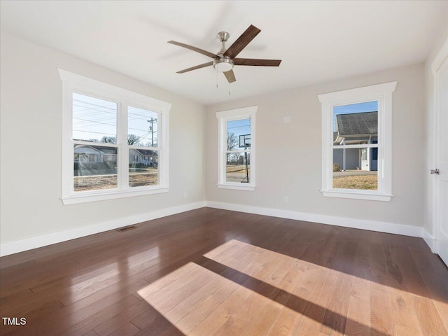 empty room featuring ceiling fan and hardwood / wood-style floors