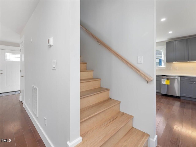 stairs with hardwood / wood-style flooring