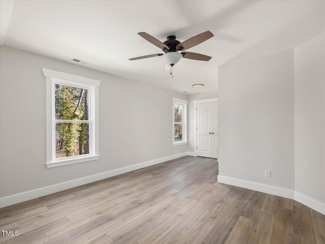 spare room featuring ceiling fan and light hardwood / wood-style floors