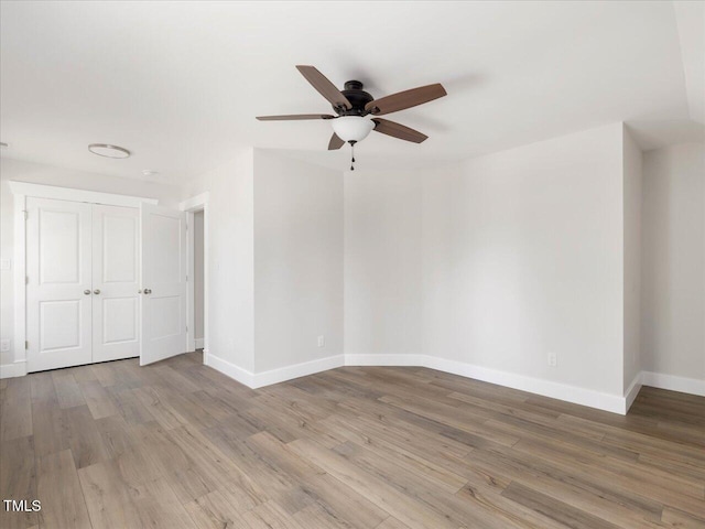 empty room featuring ceiling fan and light hardwood / wood-style flooring