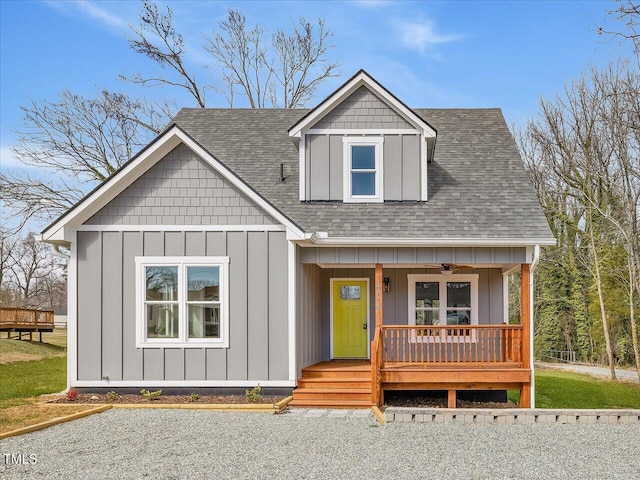 view of front facade featuring a porch, board and batten siding, and roof with shingles