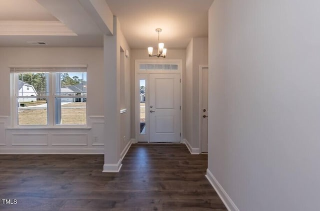 foyer with a chandelier and dark hardwood / wood-style flooring