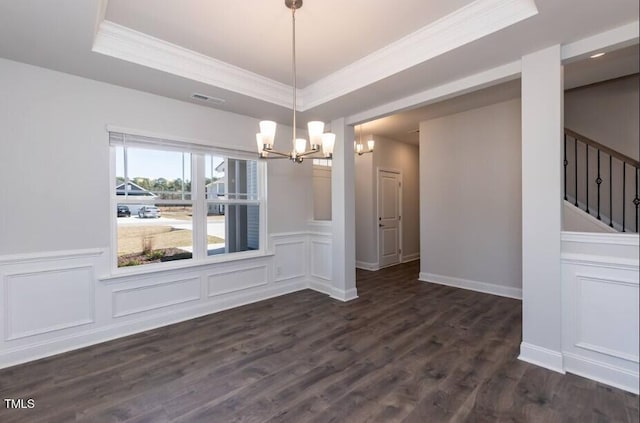 unfurnished dining area featuring crown molding, a tray ceiling, dark hardwood / wood-style floors, and a chandelier