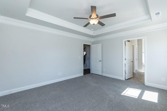 unfurnished bedroom featuring a raised ceiling, ornamental molding, carpet flooring, and ceiling fan