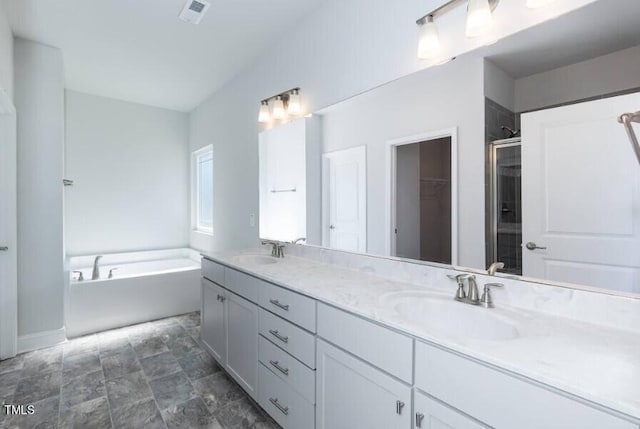 bathroom with vanity and shower with separate bathtub