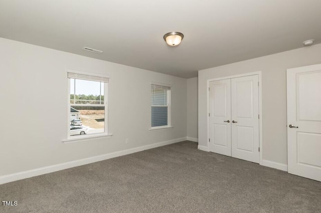 unfurnished bedroom with carpet flooring and a closet