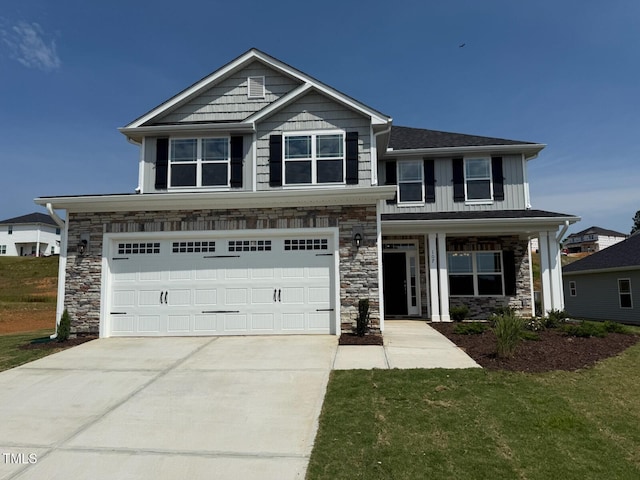 107 Northwood Dr, Fuquay Varina, NC 27526 - craftsman-style house with stone siding, a garage, concrete driveway, board and batten siding, and a front yard