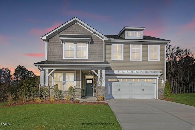 view of front of house featuring a garage, a porch, and a lawn