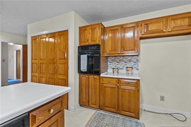 kitchen featuring tasteful backsplash and oven