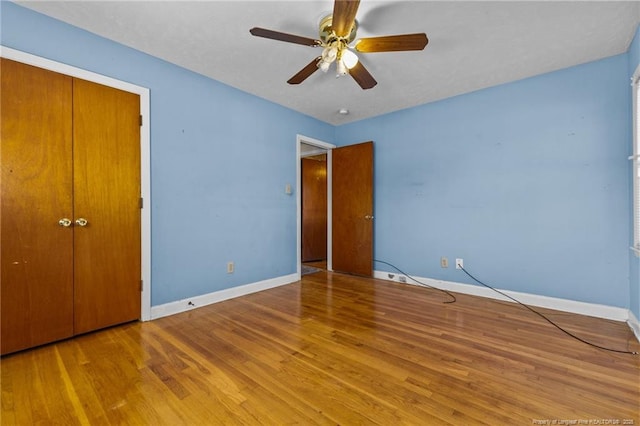 unfurnished bedroom with ceiling fan, light hardwood / wood-style floors, and a closet