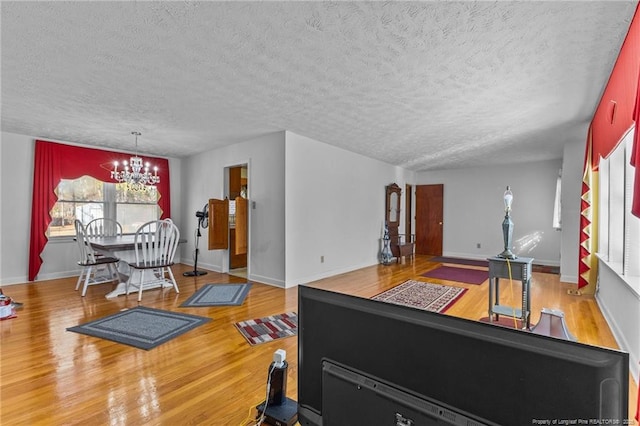 interior space with an inviting chandelier, hardwood / wood-style floors, and a textured ceiling