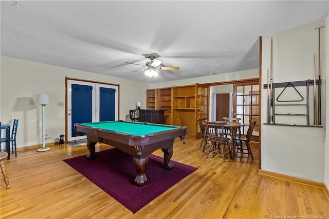 rec room with french doors, billiards, ceiling fan, and light hardwood / wood-style floors