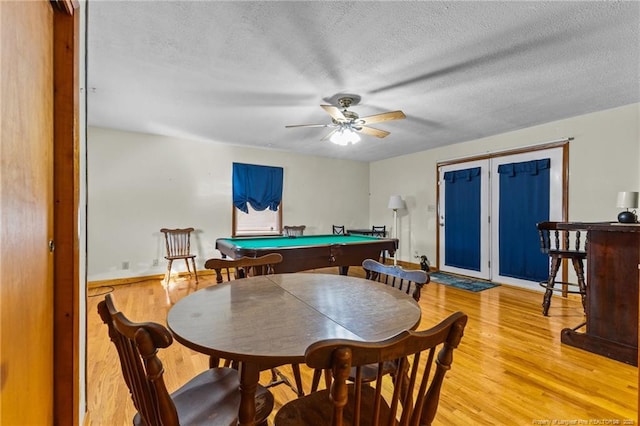 recreation room featuring billiards, ceiling fan, light hardwood / wood-style floors, and a textured ceiling