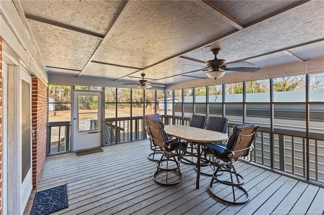 sunroom featuring ceiling fan