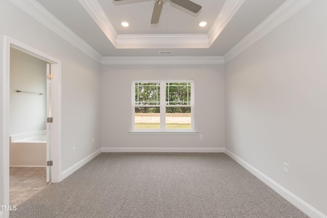 carpeted empty room with crown molding, ceiling fan, and a tray ceiling