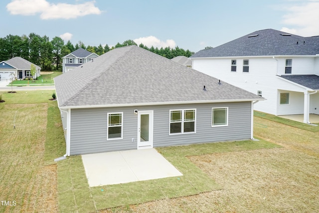 rear view of house with a yard and a patio area