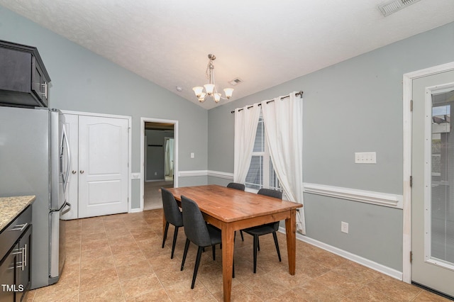 dining room featuring lofted ceiling and an inviting chandelier