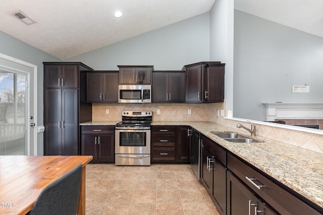 kitchen with tasteful backsplash, appliances with stainless steel finishes, sink, and dark brown cabinets