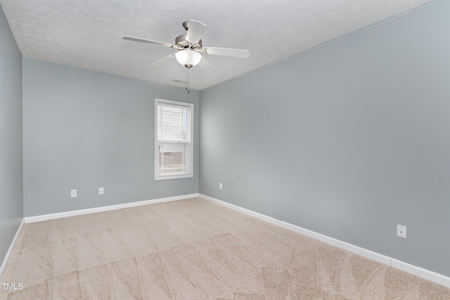 carpeted empty room with ceiling fan and a textured ceiling