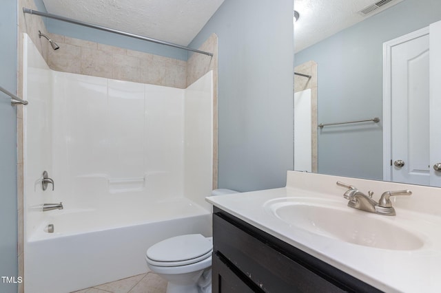 full bathroom with tile patterned floors, toilet, a textured ceiling, and vanity