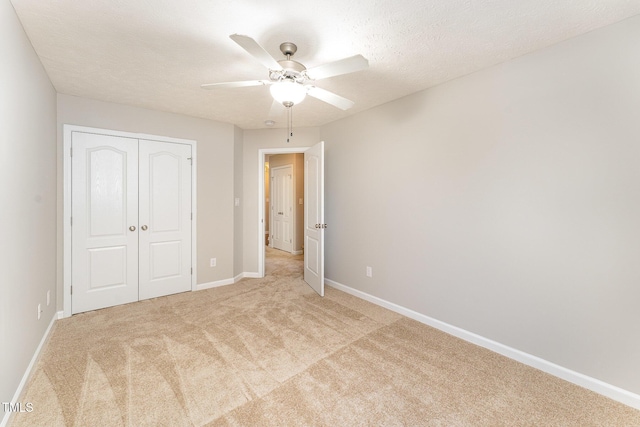 2228 Lakedale Dr, Fayetteville, NC 28306 - unfurnished bedroom with light colored carpet, a closet, baseboards, and a ceiling fan