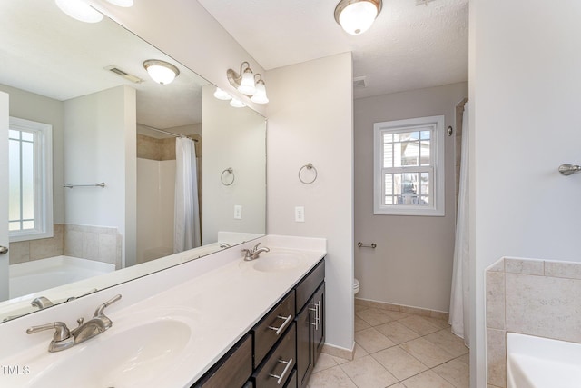 2228 Lakedale Dr, Fayetteville, NC 28306 - full bath with a garden tub, tile patterned flooring, toilet, and double vanity