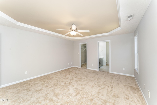 2228 Lakedale Dr, Fayetteville, NC 28306 - unfurnished bedroom featuring a raised ceiling, a spacious closet, carpet floors, a closet, and crown molding