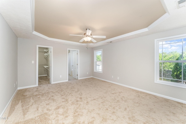 2228 Lakedale Dr, Fayetteville, NC 28306 - unfurnished bedroom featuring a tray ceiling, carpet flooring, a spacious closet, baseboards, and ornamental molding