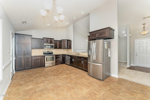 2228 Lakedale Dr, Fayetteville, NC 28306 - kitchen with stainless steel appliances, a sink, dark brown cabinetry, a chandelier, and high vaulted ceiling