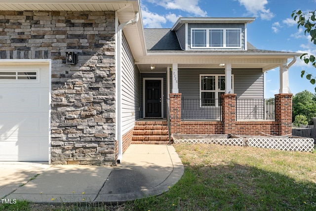 2228 Lakedale Dr, Fayetteville, NC 28306 - view of front of property with an attached garage, covered porch, stone siding, and a shingled roof