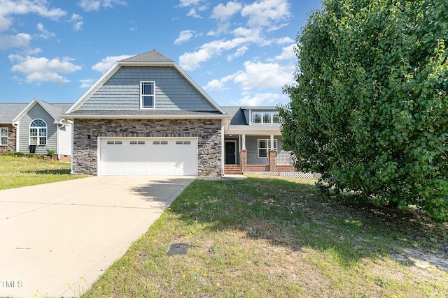 2228 Lakedale Dr, Fayetteville, NC 28306 - view of front of home with concrete driveway, covered porch, a front lawn, and an attached garage