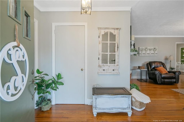 entryway featuring crown molding and hardwood / wood-style flooring