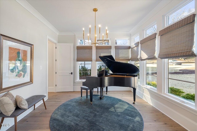 misc room featuring hardwood / wood-style floors, crown molding, and a wealth of natural light