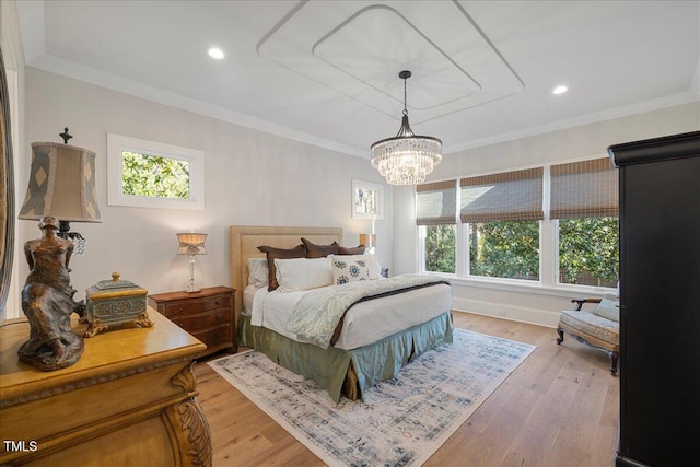 bedroom with hardwood / wood-style flooring, crown molding, and an inviting chandelier