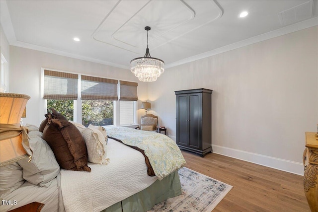 bedroom featuring an inviting chandelier, crown molding, and light wood-type flooring