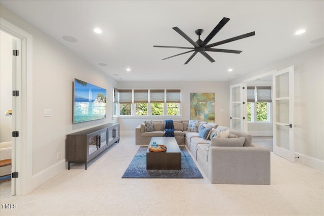 carpeted living room featuring french doors, ceiling fan, and a healthy amount of sunlight