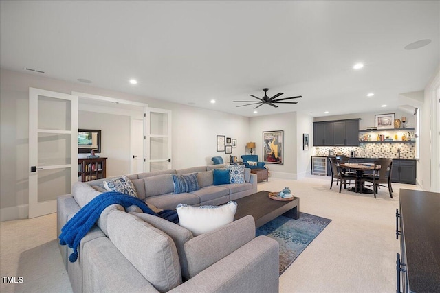 carpeted living room with ceiling fan